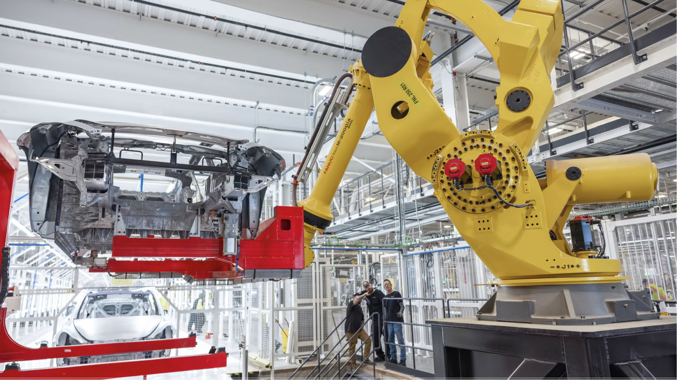 Robotic arms on an EV assembly line