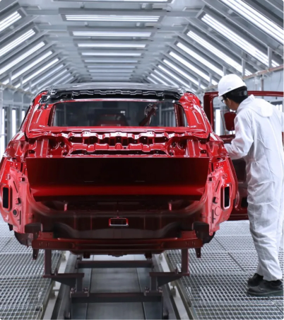 EV body shell in production, technician inspecting the frame