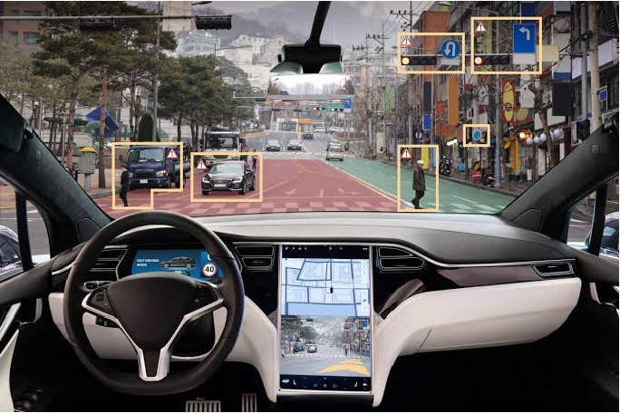 Vehicle interior showing full self-driving controls on a city street