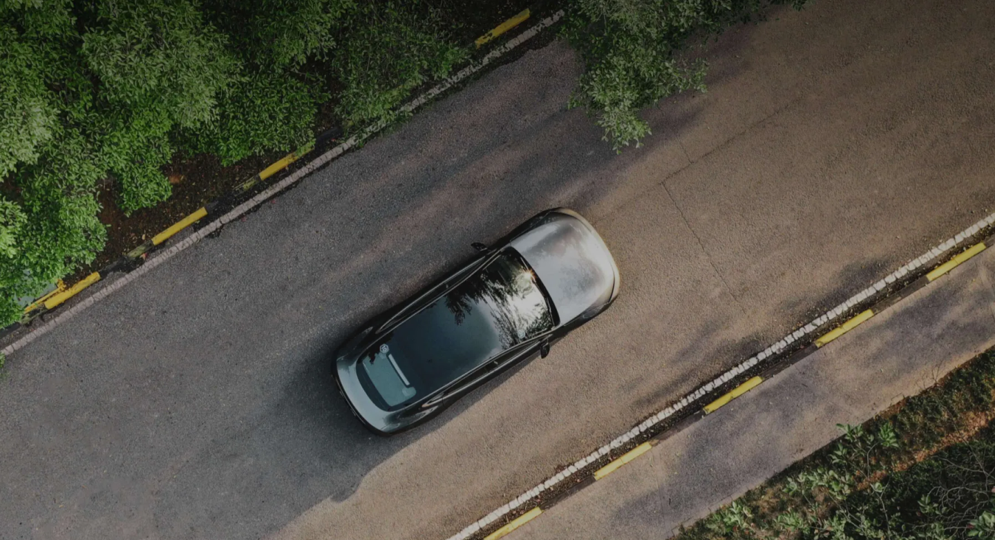 Aerial view of a SUN Motors vehicle on a forest road