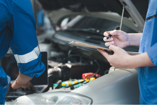 SUN Motors specialists reviewing a vehicle diagnostic tablet