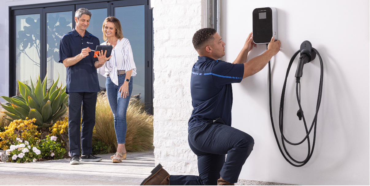 Technician installing a home EV charging station
