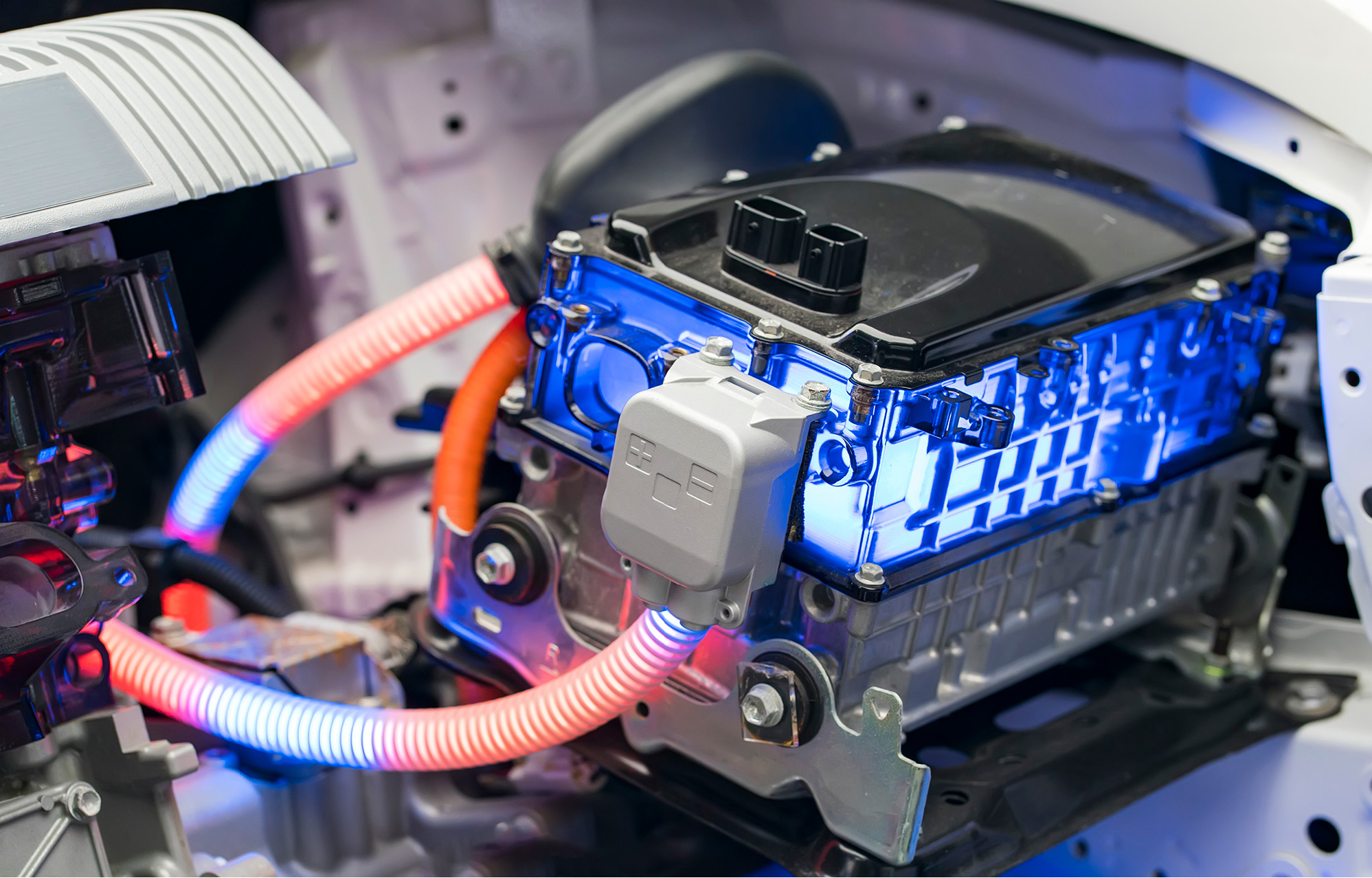 Close-up of a high-voltage EV battery and cooling system during service